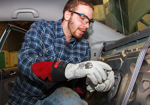 Student working on the interior of a car