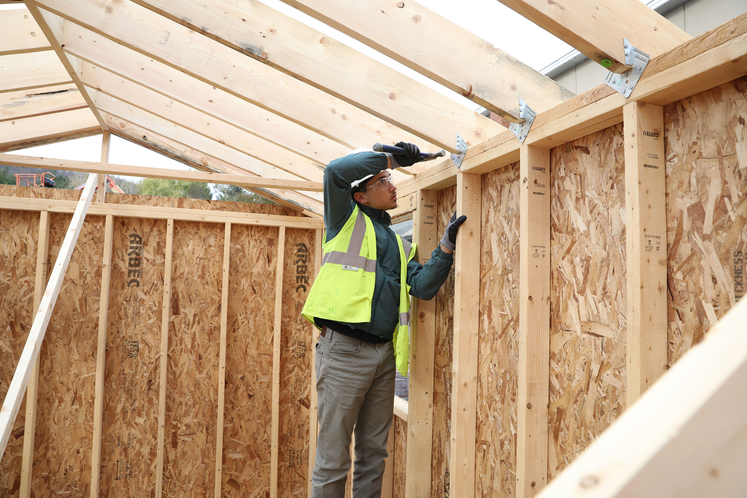 Worker framing a house