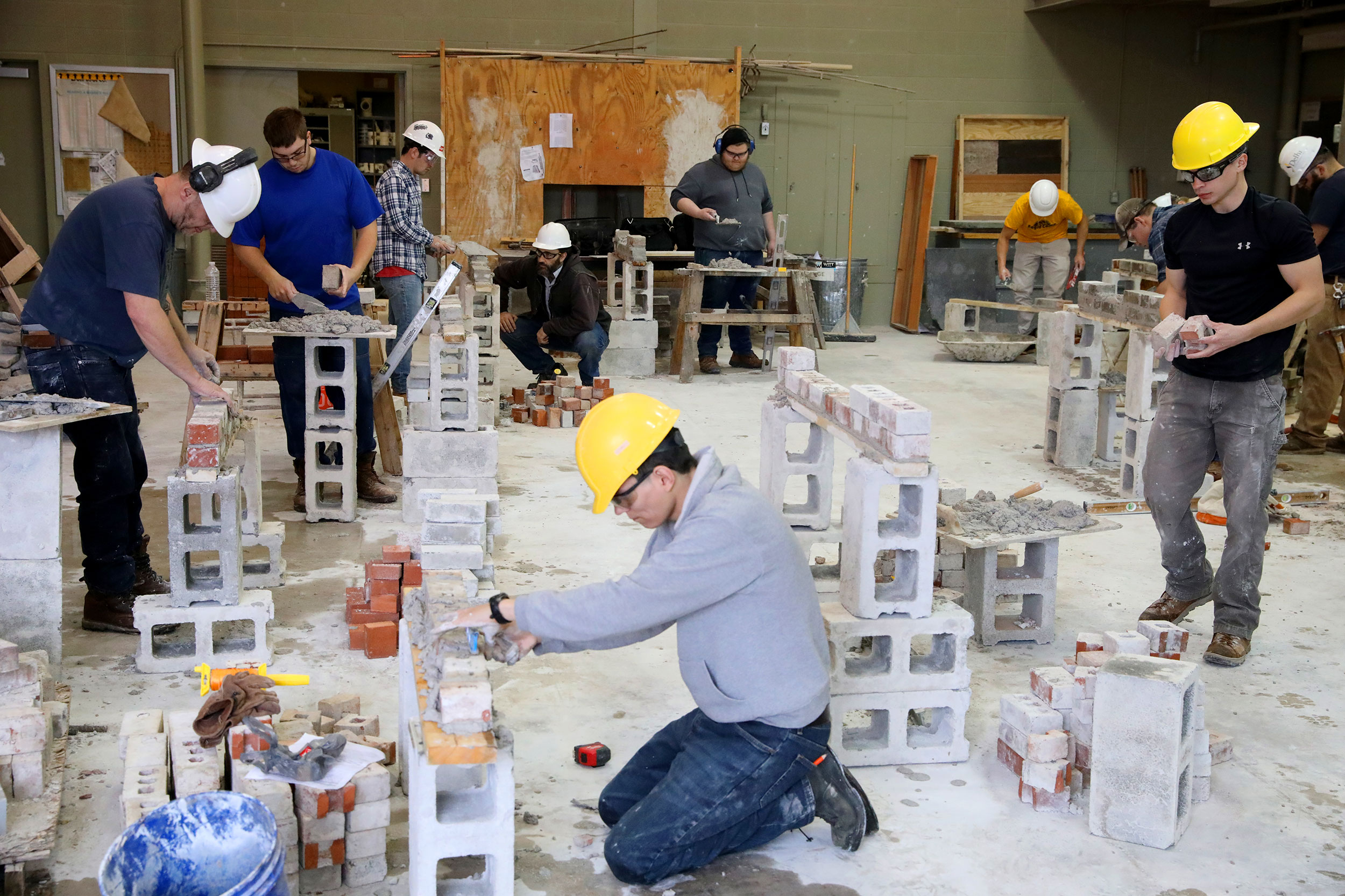 Student in shop working with cinderblocks
