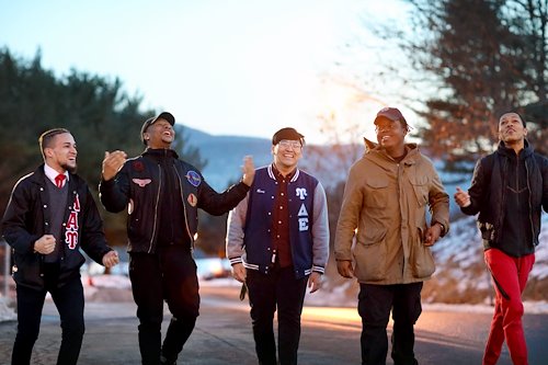 Students walking down a road and laughing