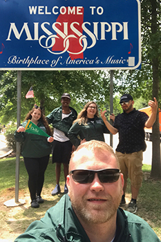 Instructor in front of Mississippi sign