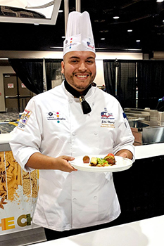 Julio Chavez dispalys winning dish at competition