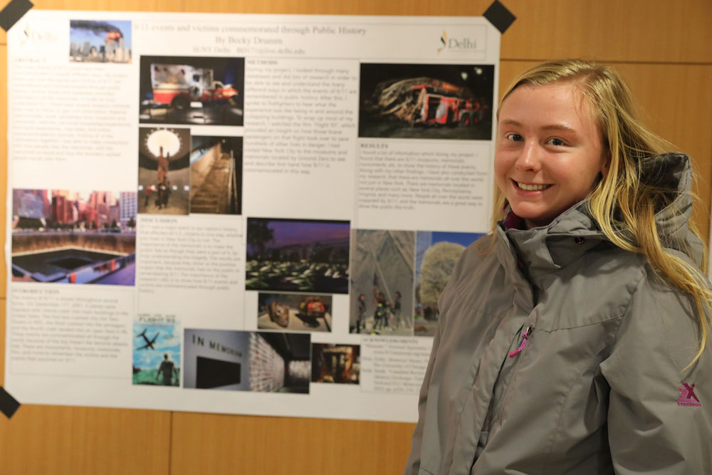 Becky Drumm in front of wall paroject