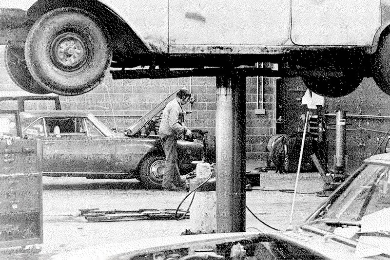 Student working on vintage car in automotive lab