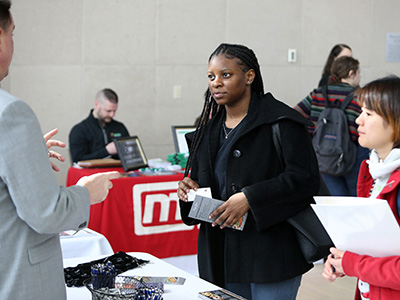 2 Students talking with employer