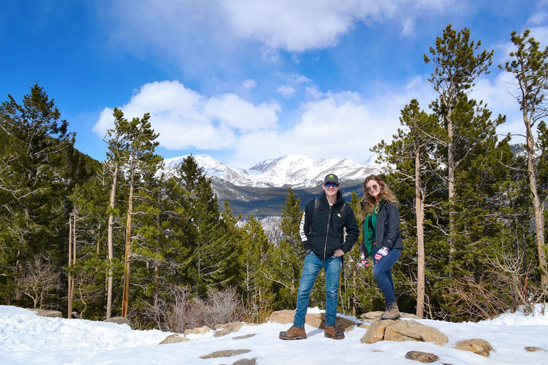 Students posing with mountains in background