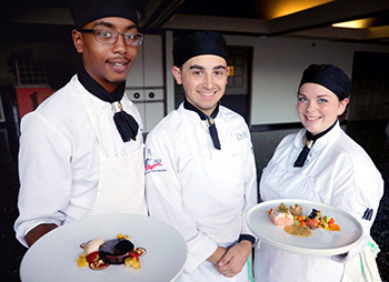 Winning Culinary team displaying their dishes