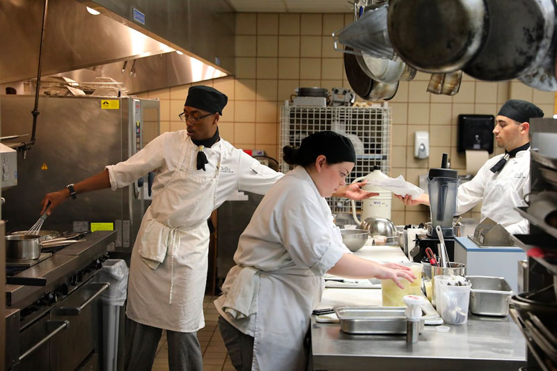 Students in kitchen preparing food for Copa Culinaria competition