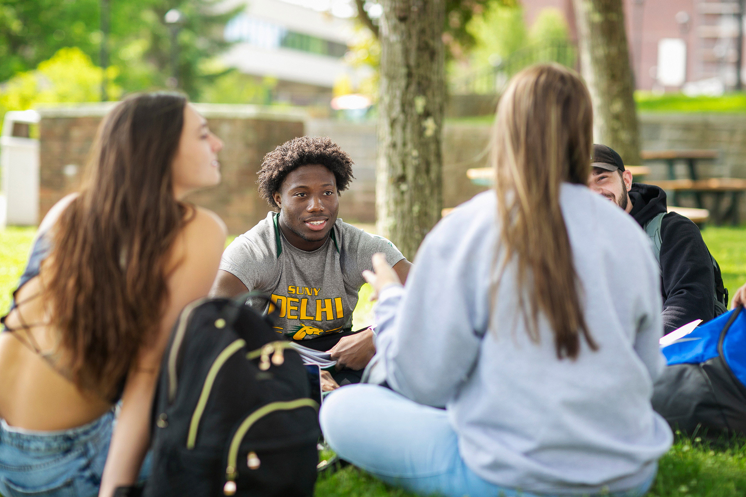 Students sitting on gound