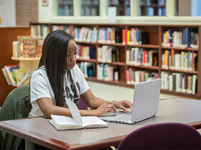 Student working online with their laptop