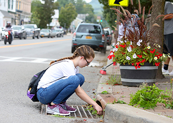 A student cleaning the street in town