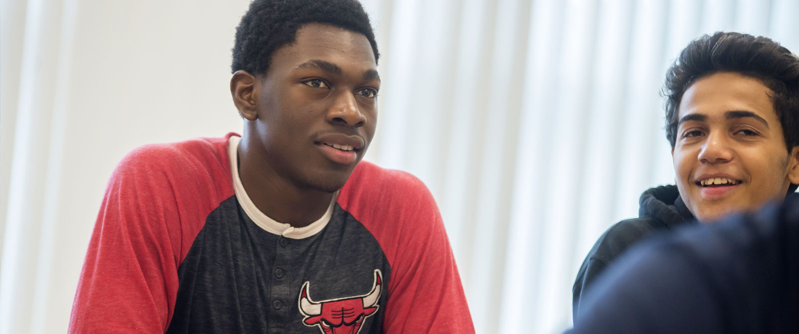 Two students in class having a conversation