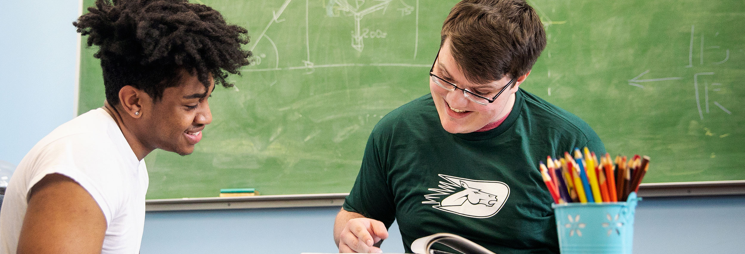 Student getting tutored at desk