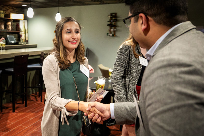 Students networking in the Kennedy Lounge