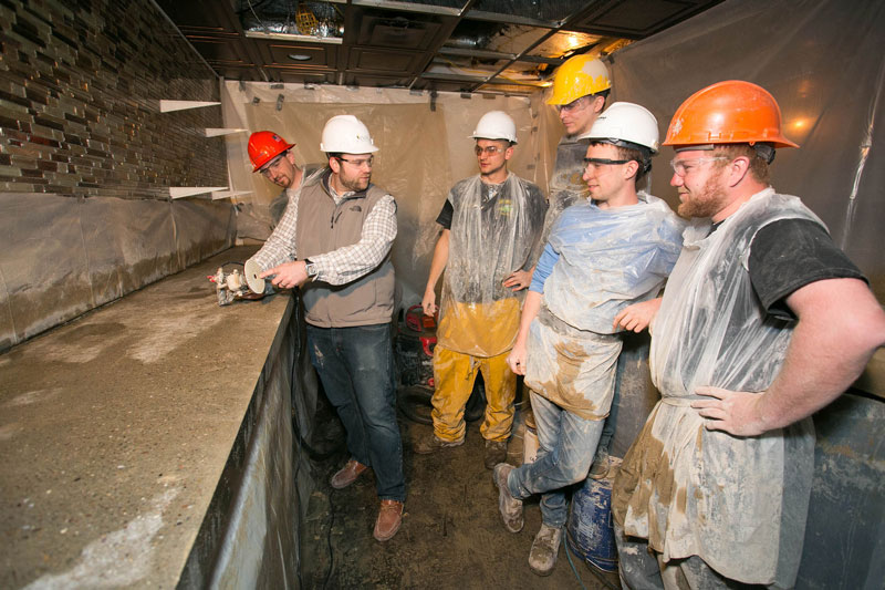 Construction Technology students and faculty working in building