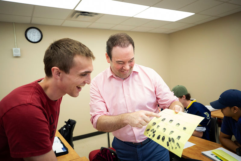 Facuty member Scott Swayze talking to a student