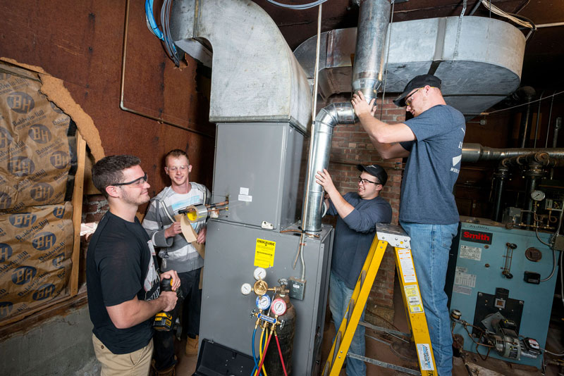 Students working on HVAC system in lab