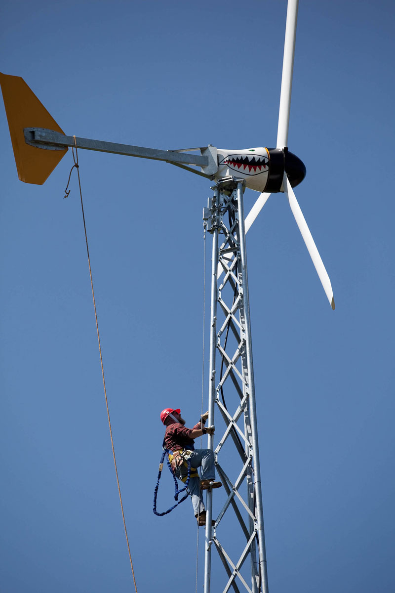Student climbing wind turbine