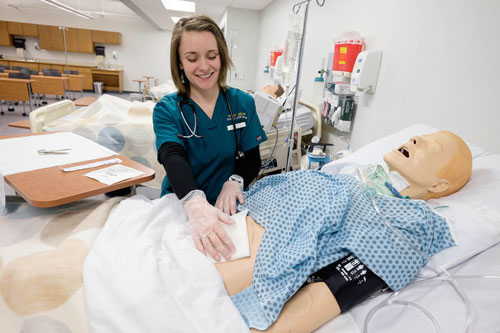 Student practicing on mannequin in lab