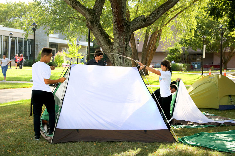 Students erecting tent outdoors
