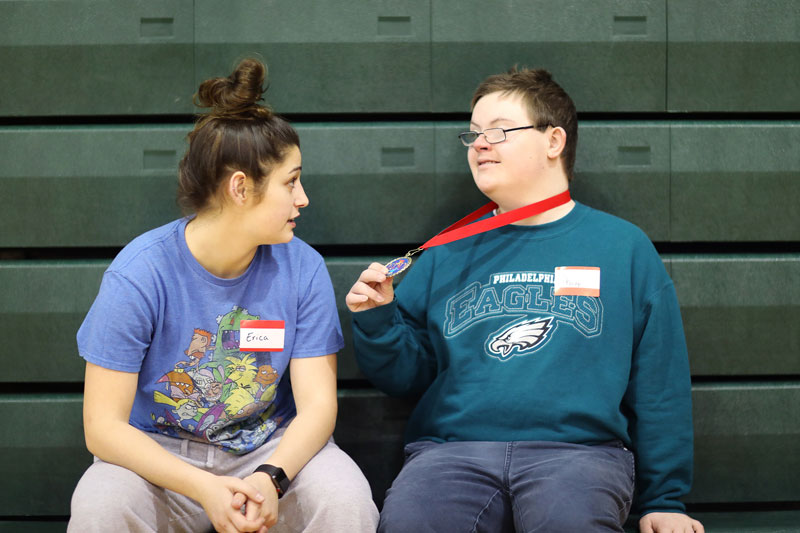 Student talking to young man