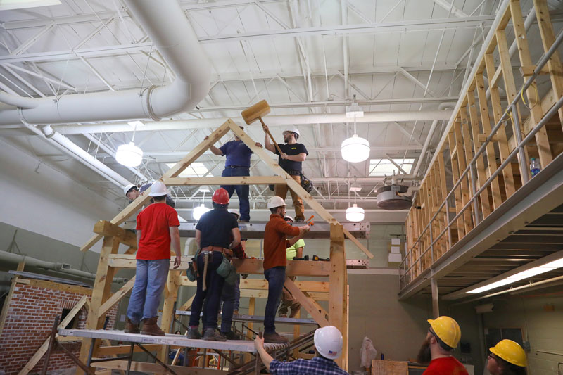 Students building support beams