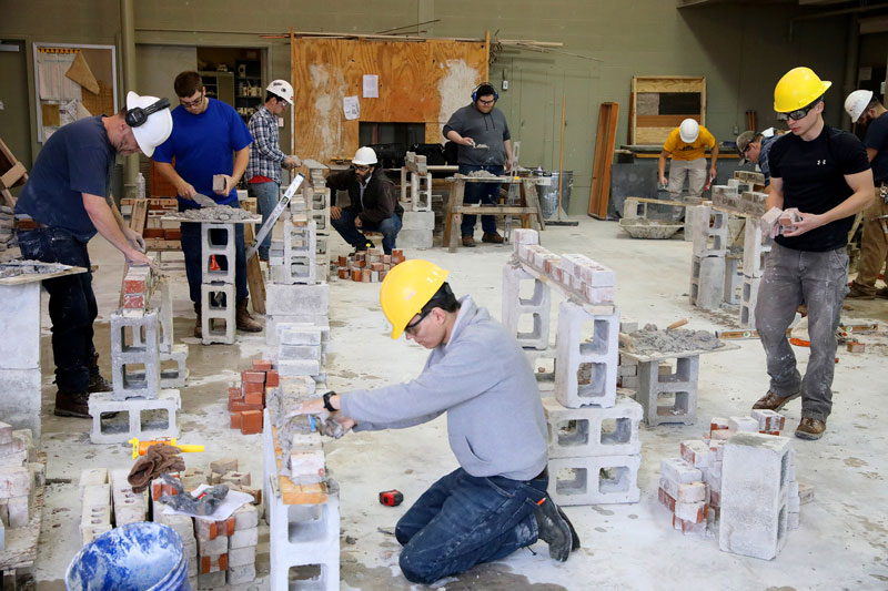 Students working on masonry project indoors