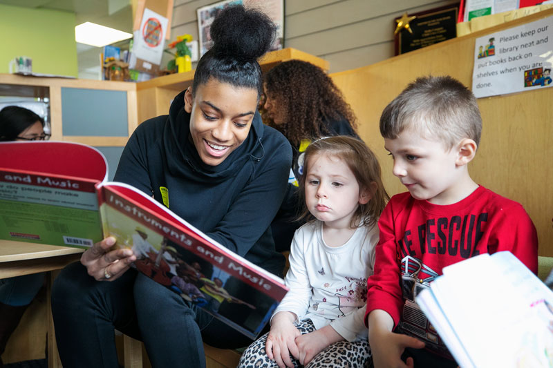 Student talking to young children