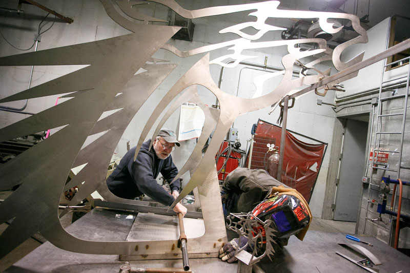 Faculty and student working on Delhi Bronco statue