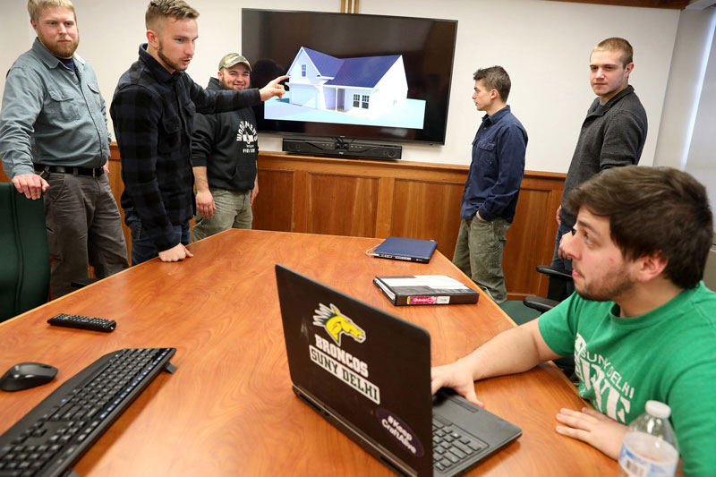 Students showing construction model