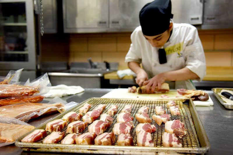 Student preparing food in kitchen