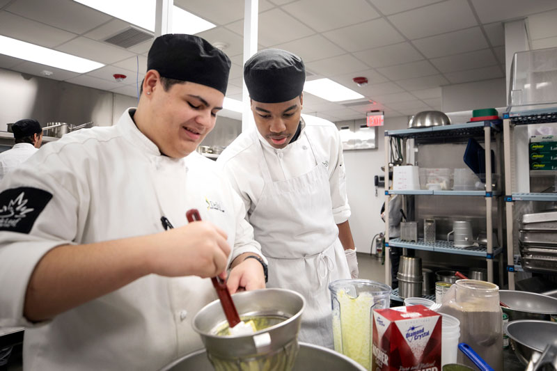 Students preparing food in kitchen