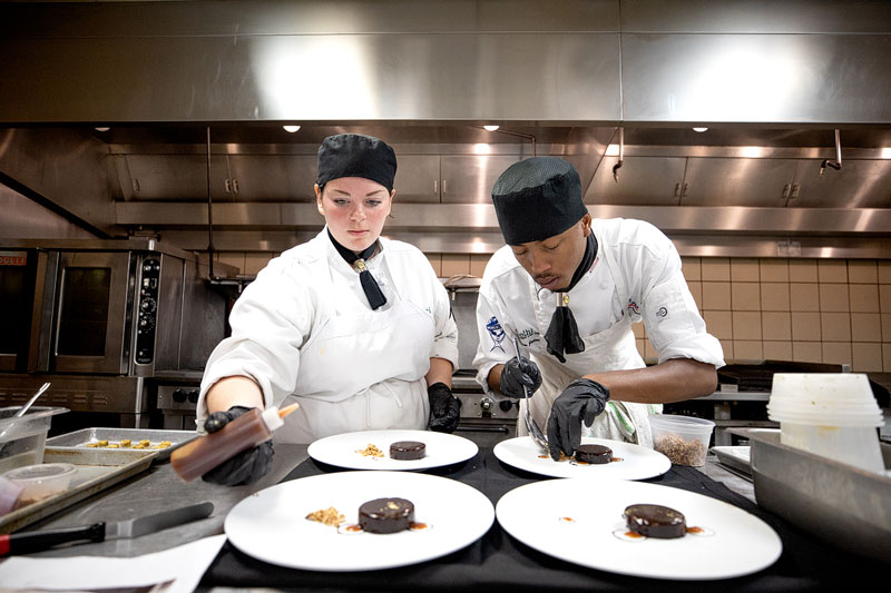 Students preparing food in kitchen