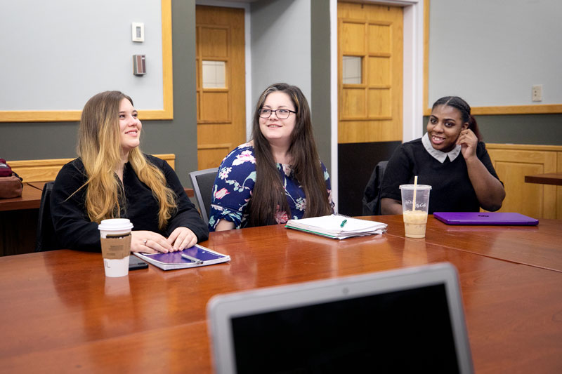 Students sitting at table in classroom