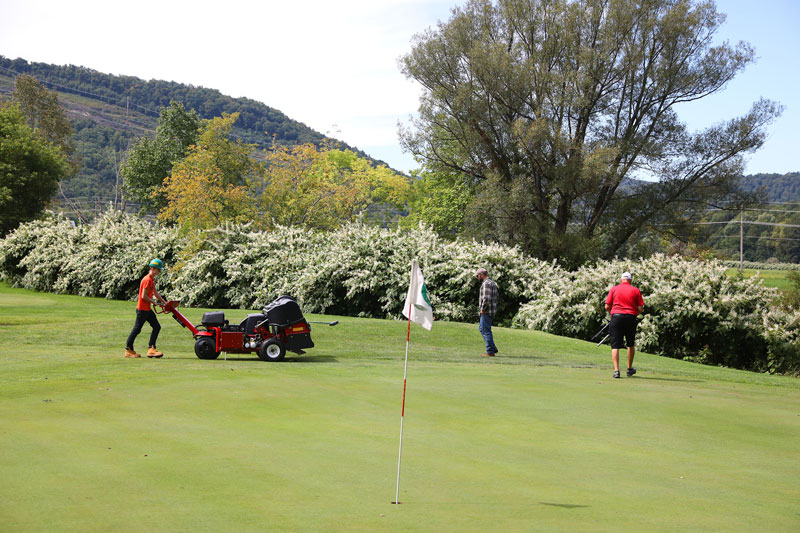 Students working on turf at golf course