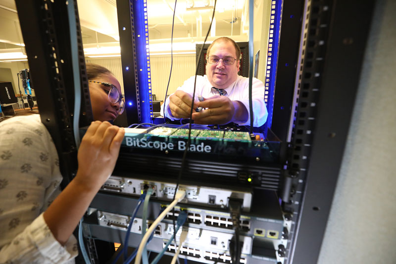 Student looking at inside of computer