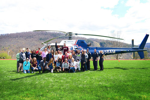 Nursing students in front of helicopter