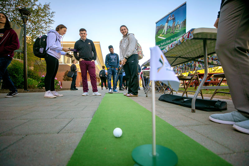 Students practicing on putting green