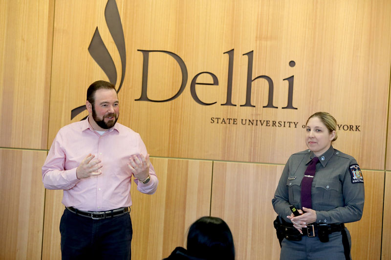 Faculty member Scott Swayze and law enforcement officer in classroom