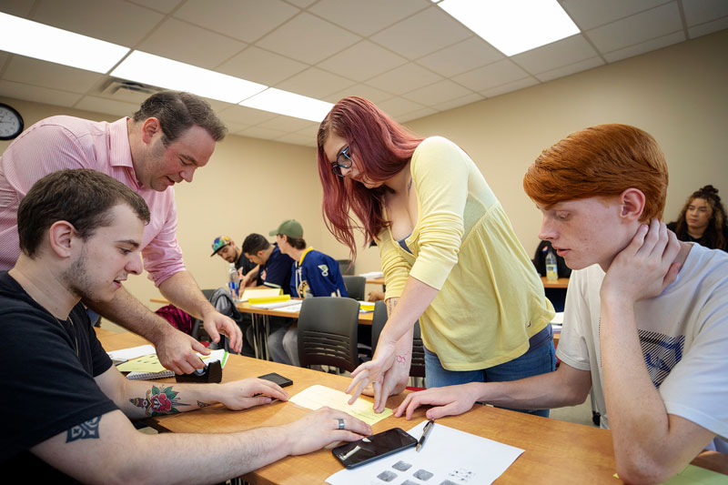 Criminal justice students learning how to take fingerprints