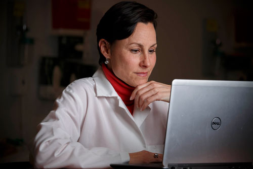 Nursing faculty member at computer
