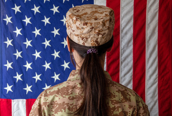female veterans in front of american flag