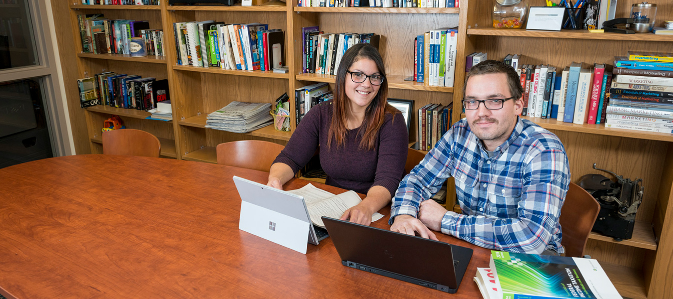 Students studying in the library with laptops