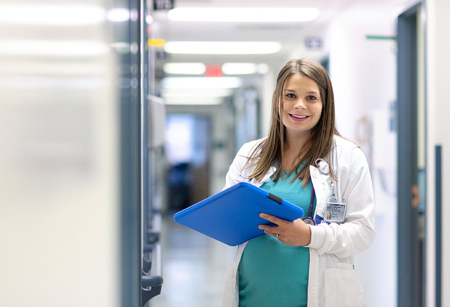 Nursing student holding a blue tablet