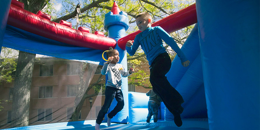 Kids in bounce house at Family Weekend