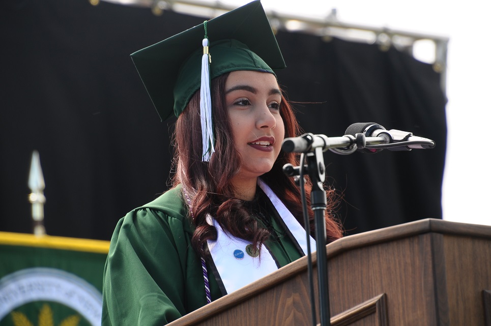 Graduate speaking at podium