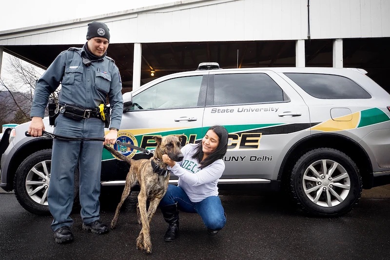 Police Officer, student and dog