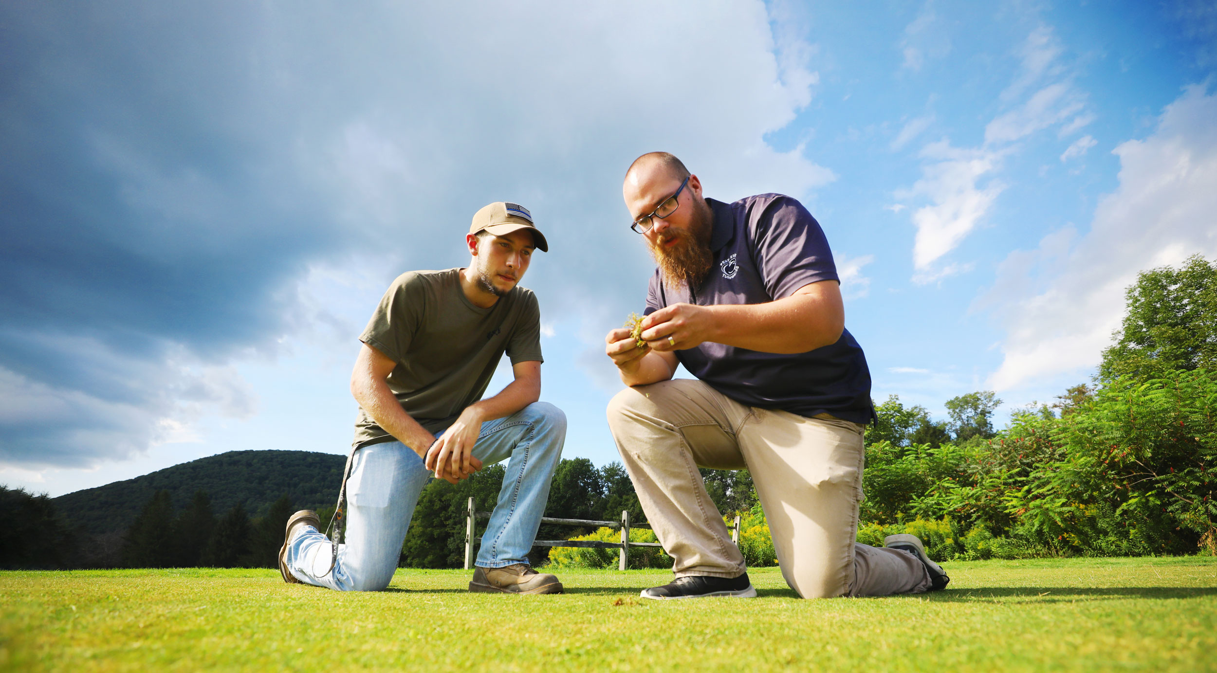 Student and instructor inspecting turf