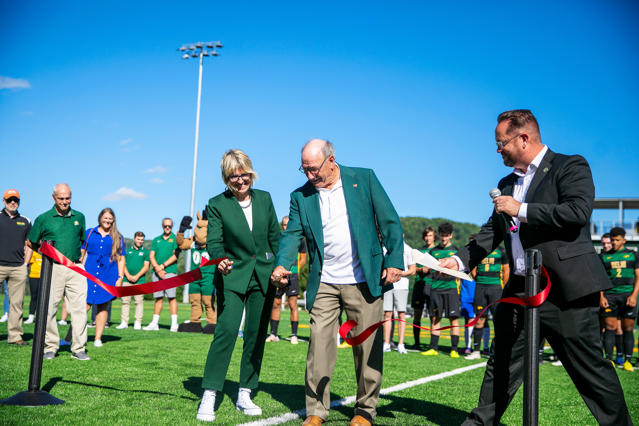 Two people at a ribbon cutting