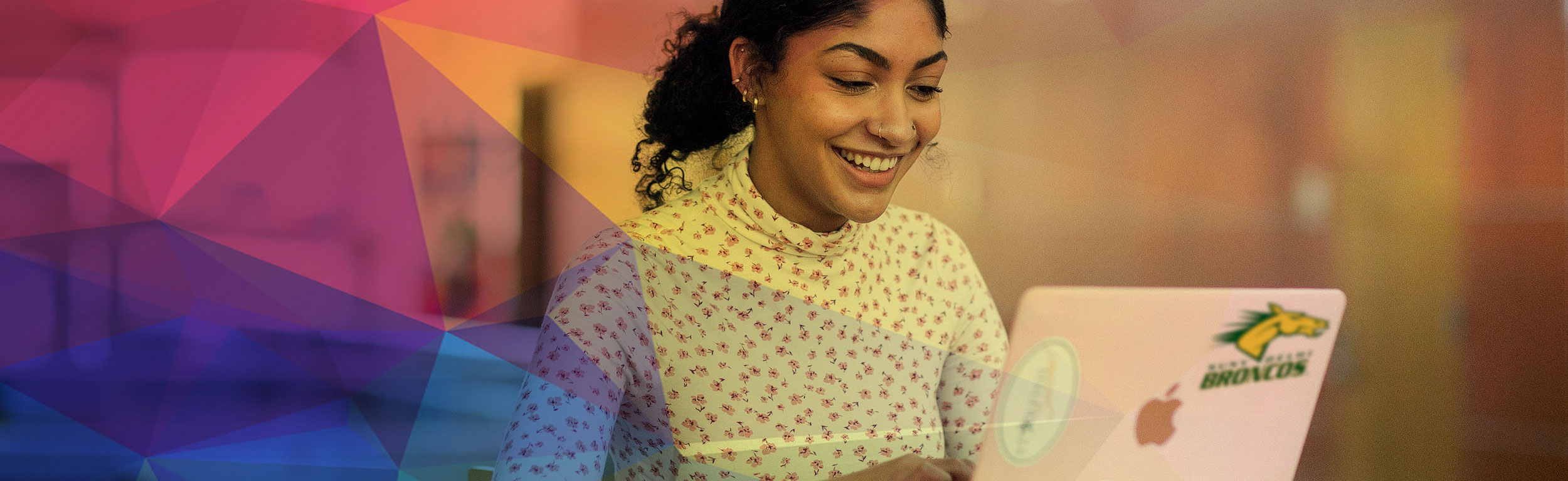 Girl laughing at Computer